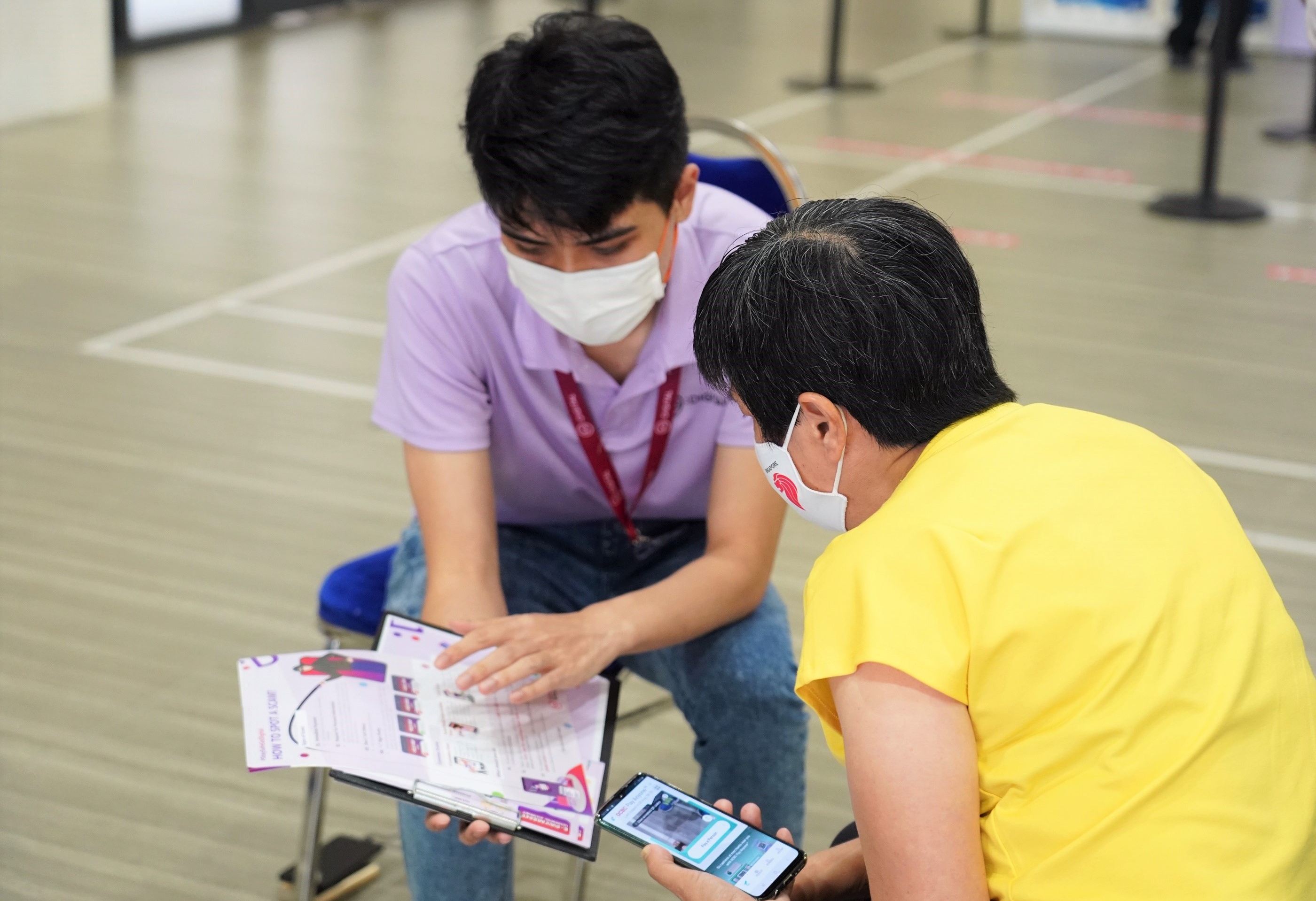 Digital ambassador helping an elderly using a guide
