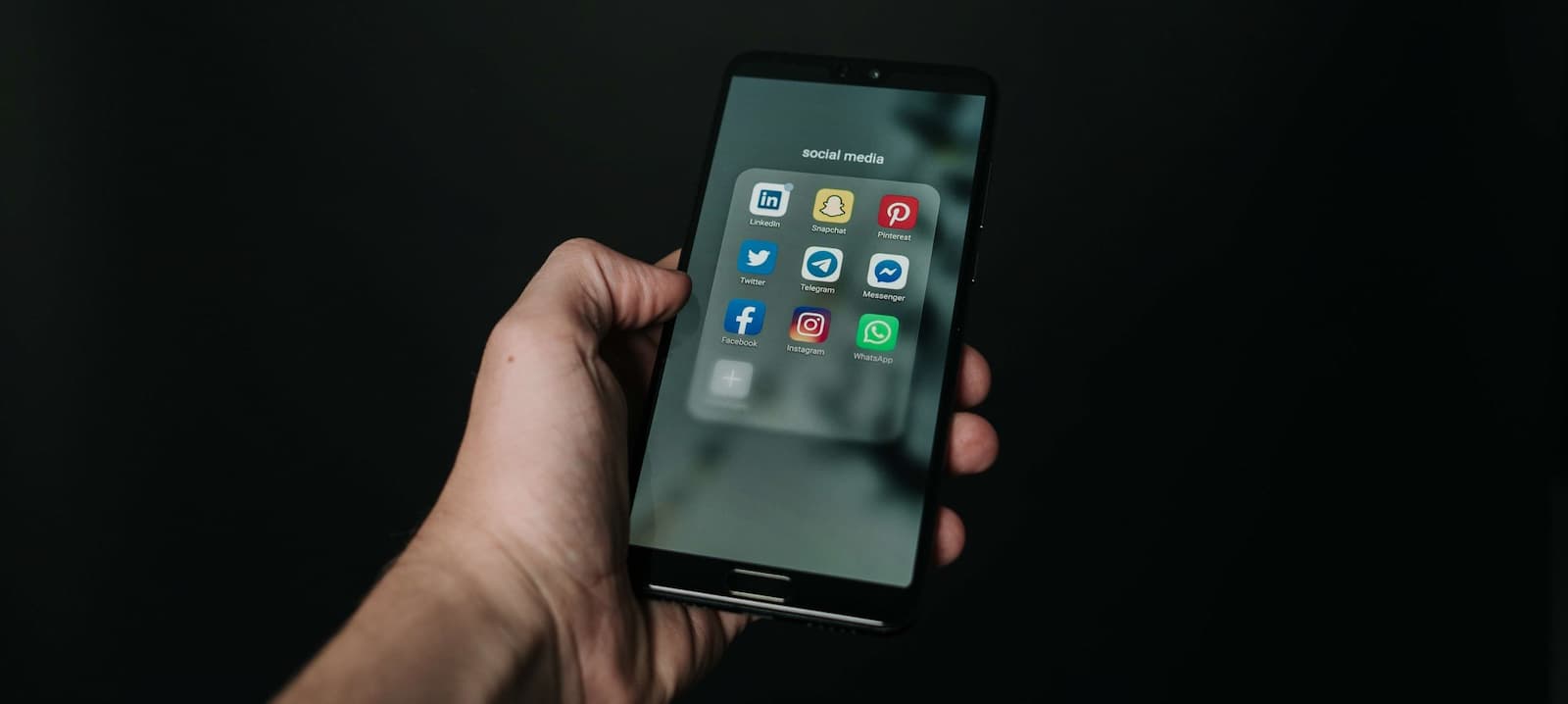 Person using a smartphone to thoughtfully review and edit a social media post.