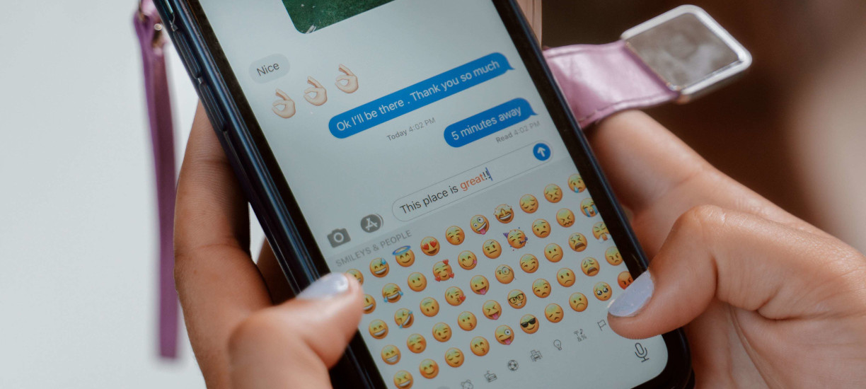 A handphone showing a chat log of someone chatting.